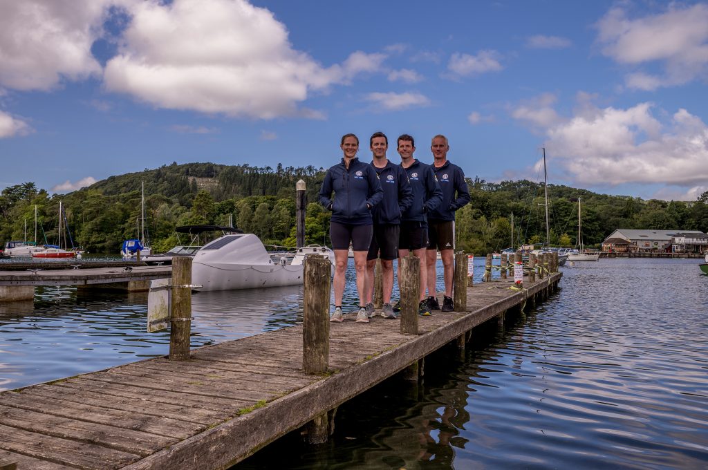 Four team members stood on a pontoon